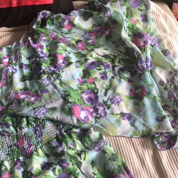 This is a floral jumpsuit with a scarf attached to the top of it on one side. - Picture 3 of 7